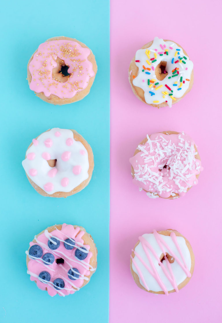 Beautifully decorated donuts sitting on colored paper